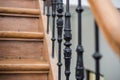 Staircase Handrailing in Old Historic Building. Interior Decor of Vintage Stairs with Metal Ornament and White Wall Background. Royalty Free Stock Photo