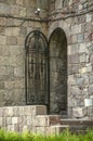 Staircase leading to arched doors with wrought-iron openwork door to exit from the courtyard of Geghard monastery in Armenia