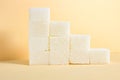 A staircase lined with white sugar cubes on a beige background Royalty Free Stock Photo