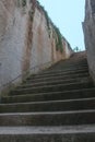A staircase made of stone cuts through a natural cliff Royalty Free Stock Photo