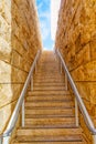 Staircase Within A Narrow Passage Leading Up Toward The Sky