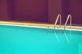 Staircase pool of outdoor swimming pool in old hotel with brown wall Royalty Free Stock Photo