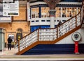 A staircase on a railway station concourse with a cafe above and a weighing machine below Royalty Free Stock Photo