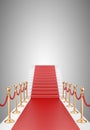 Staircase and red carpet between two gold stanchions with rope Royalty Free Stock Photo