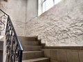 A staircase with stone steps, carved wrought iron railings and brick walls. Location, interior inside Royalty Free Stock Photo