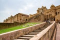 A staircase to Amber Fort in Jaipur, India with tourists going upstairs Royalty Free Stock Photo