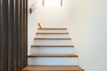Staircase wooden with wooden handrails on white wall in modern home. Interior structure design concept. Empty pathway of stairway Royalty Free Stock Photo