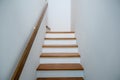 Staircase wooden with wooden handrails on white wall in modern home. Interior structure design concept. Empty pathway of stairway Royalty Free Stock Photo