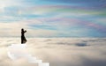 Girl Silhouette on stairs above the clouds rainbow sky straiway to heaven Royalty Free Stock Photo