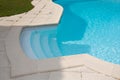 Stairs access to water blue swimming pool detail side Royalty Free Stock Photo