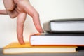 Stairs from books. Hand symbolizes that a man climbs the ladder of knowledge on a white background, close up