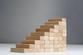 Stairs to success build with wooden blocks on grey background with copy space Royalty Free Stock Photo