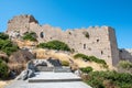 Stairs through bushes to ruins of medieval castle Kritinia Rhodes, Greece