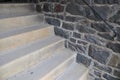 Stairs of concrete next to wall of natural stones Royalty Free Stock Photo