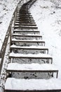 Stairs covered snow leading steep hill winter Royalty Free Stock Photo