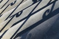 Stairs with curled railing shadows Royalty Free Stock Photo