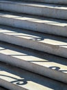 Stairs with curled railing shadows, vertical orientation