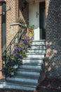 Stairs decorated with petunias to the front door of a house in t Royalty Free Stock Photo