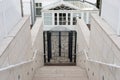 Stairs down to a closed gate in front of the entrance hall Royalty Free Stock Photo