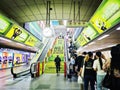 Stairs and Escalator in the hall of BTS Skytrain station, Long queues stuck waiting at the bottom of the escalators