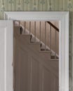 Stairs framed by white wooden doorway