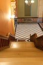 Stairs leading down to tiles diamond pattern floor in French Renaisance style.