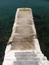 Stairs leading to cement pier on turquoise sea. Royalty Free Stock Photo