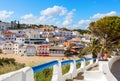 Stairs leading to the sandy beach surrounded by typical white houses, Carvoeiro, Algarve, Portugal Royalty Free Stock Photo