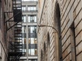 Fire escape stairs and ladder, in metal, on a typical North American old brick building from Montreal, Quebec, Canada. Royalty Free Stock Photo