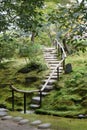 Stairs made of stones in a beautiful Japanese garden in Arashiyama, Japan. The ground is covered with green moss Royalty Free Stock Photo