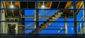 Stairs in a modern staircase building with glass windows, lighted at night, dutch architecture Royalty Free Stock Photo