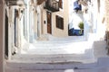 Stairs in the narrow street of Neorio town on Poros island, Greece; summer background Royalty Free Stock Photo