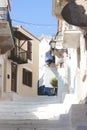 Stairs in the narrow street of Neorio town on Poros island, Greece; summer background Royalty Free Stock Photo