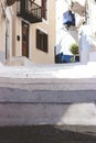 Stairs in the narrow street of Neorio town on Poros island, Greece; summer background Royalty Free Stock Photo