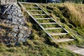 Stairs sunk into the slope resembling a wooden ladder at the same time as the terrain. fortification of a slope in front of a larg