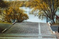 Stairs to the embankment in yellow leaves. Steps in the autumn. Royalty Free Stock Photo