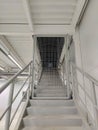 Stairs to the hangar roof in perspective with an iron grating for security against criminal intrusion Royalty Free Stock Photo