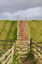 Stairs to nowhere under gathering storm clouds
