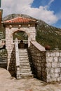 Stairs to Roman catholic church our lady of the rocks on island islet in boka kotor bay near perast town in front of mountains ran Royalty Free Stock Photo