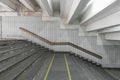 Stairs to the shabby underpass or subway station. Side view of empty stairs with a wall lined with ceramic glossy tiles