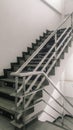 Stairs up in the building with stainless steel handrails.