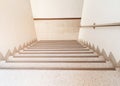 Stairs walkway down terrazzo flooring in interior building