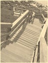 Stairway down to a rocky beach in Sepia