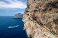 Stairway in limestone rock to stalactite Neptune cave. Boat leaving Grotte di Nettuno in Sardinia, Italy