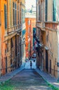 Stairway between old buildings with colorful walls on narrow street in old quarter of historical centre of Genoa