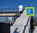 Stairway overhead pedestrian crossing covered with snow. Sign crosswalk. Poor utilities work