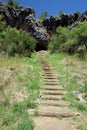 Stairway to a cave entrance in a hill Royalty Free Stock Photo