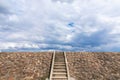The stairway to the dam is filled with stone on the background of a white cloud Royalty Free Stock Photo