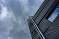 Stairway to Heaven. Metal staircase on the building against the background of the sky and clouds Royalty Free Stock Photo