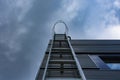 Stairway to Heaven. Metal staircase on the building against the background of the sky and clouds Royalty Free Stock Photo